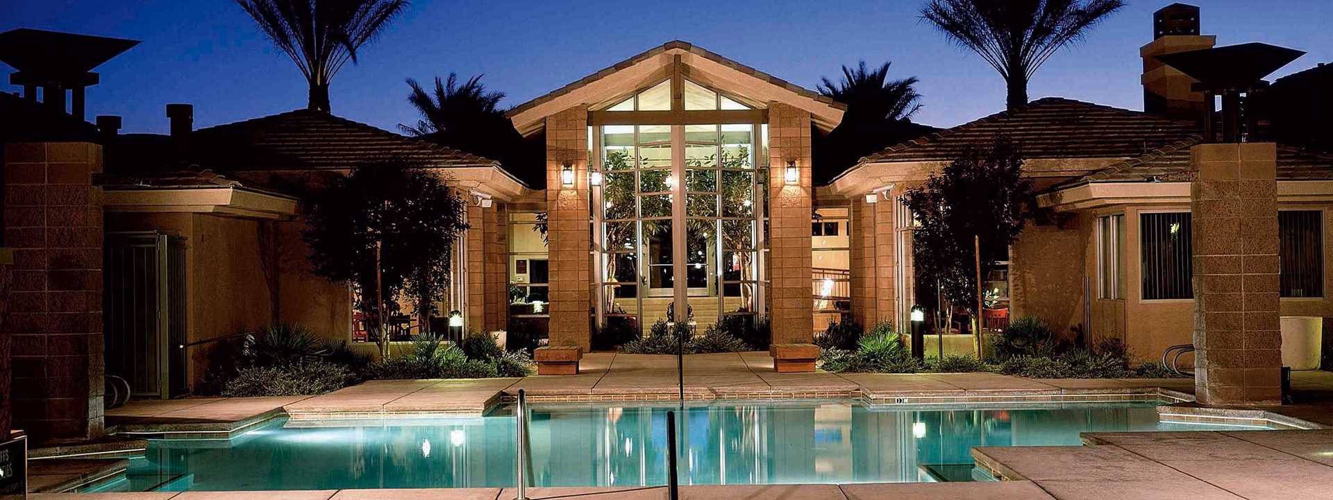 The Cliffs At Peace Canyon in Las Vegas, Nevada. Night time view with pool in the foreground and hotel club house in the background.